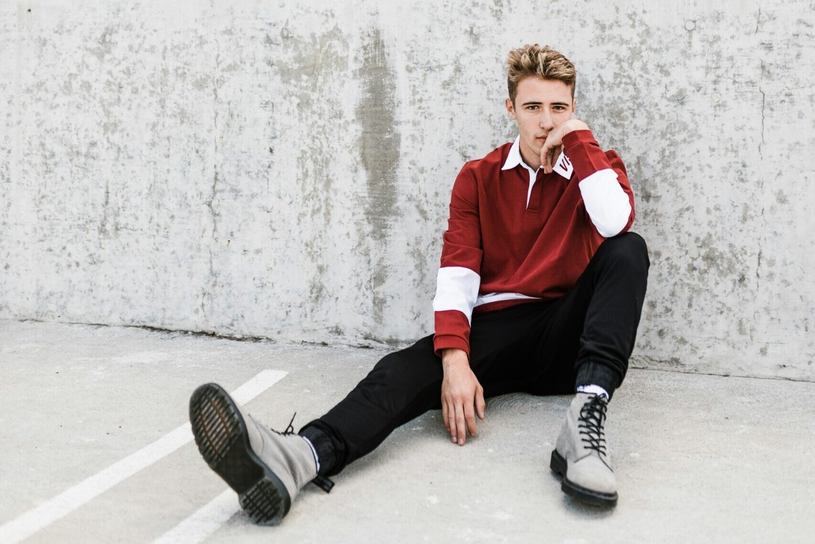 person sitting on white concrete flooring